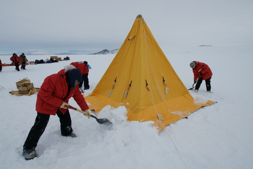 The Scott tent partially installed. We have to cover the skirts with snow, and then dig eight \'deadmen\' in the ice to hold the tent ropes. (click to enlarge)
