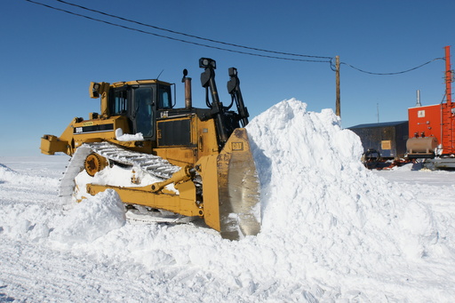 A Caterpillar D8 bulldozer shifting some of the 30cm of snow that fell overnight on the airfield. (click to enlarge)