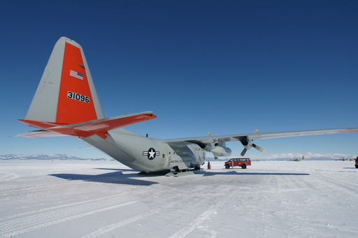 Our LC-130  aircraft for the flight to Pole, with perfect views to distant mountains, 50-100 km away. The wide-angle lens exaggerates the size of the tail. (click to enlarge)