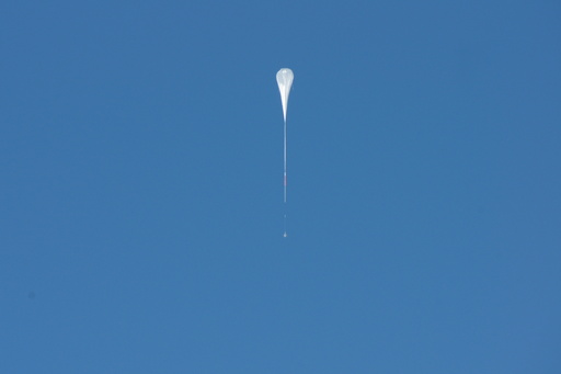 A stratospheric balloon launch on Christmas day. The payload weighs about 2 tonnes and is of the order of 3 metres on a side. (click to enlarge)