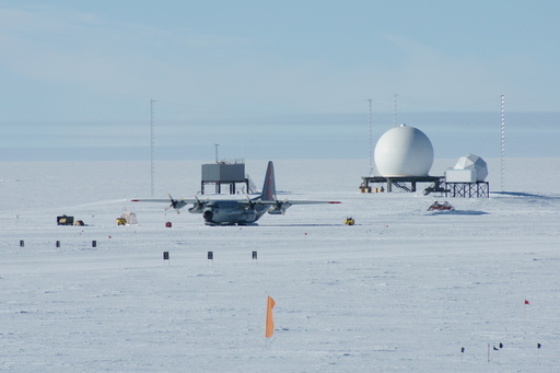 The LC-130 with mechanical problems, parked at Pole. The two radomes house microwave dishes for communication with near-geostationary satellites. (click to enlarge)