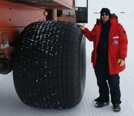 The Deltas have seriously wide tires to distribute their weight on the sea ice. That\'s me wearing \'Big Red\', the affectionate name for our Antarctic parkas. (click to enlarge)