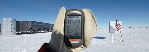 You can\'t get much further south than this! The GPS is reading S90d 00.000m. The Jan 1, 2011 Geographical Pole is to the right, and the Ceremonial Pole is in the background, even further to the right. (click to enlarge)