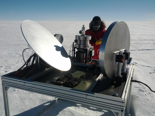 Craig working on the HEAT telescope. The large flat mirror reflects light into a 2nd and 3rd mirror before reaching the detector in the cryostat (to the left of Craig). The detector is cooled to -220C, yes, that is minus two hundred and twenty Celsius. CREDIT: Luke Bycroft. (click to enlarge)